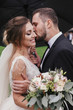 © sonyachny - Gorgeous bride and stylish groom passionately kissing under umbrella in rainy outdoors. Sensual wedding couple embracing. Romantic moments of newlyweds. Modern wedding photo