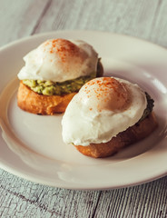 Wall Mural - Sandwiches with guacamole and poached eggs