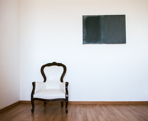 Wall Mural - Empty room with armchair and white wall. Abstract accommodation. Minimalism in lodging.