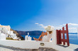 © Netfalls - Luxury travel vacation woman looking at view on Santorini island