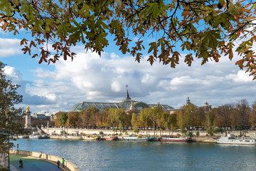 Wall Mural - Grand Palais building view from the Seine river under a vivid blue sky of Paris