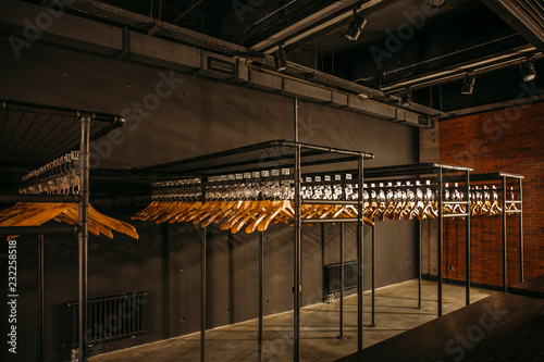 Cuadros en Lienzo Wooden hangers with numbers in dark empty cloakroom or checkroom or wardrobe