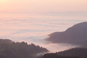 Wall Mural - pink clouds over mountains in the morning