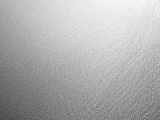 Wall Mural - gray sand beach texture with sunlight