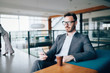 © NDABCREATIVITY - Pensive young businessman in cafe using phone