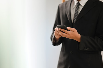 Cropped shot of Businessman using mobile phone.