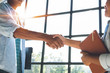 Business people shaking hands - businesswoman making handshake with a businessman.