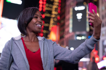 Canvas Print - Woman in city at night taking selfie picture