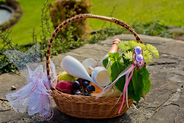 Wedding basket with fruit and a bottle of champagne.