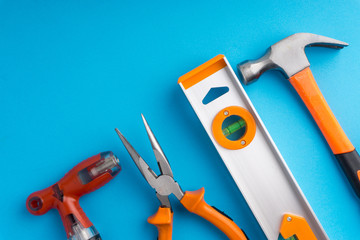 Set of working tools on blue background with selective focus and crop fragment