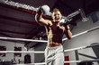 © zamuruev - Boxer. Confident young boxer punching, training on the boxing ring