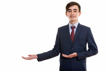 Studio shot of young happy Persian teenage businessman smiling w