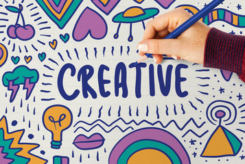 Wall Mural - woman drawing the word creative typography on a board