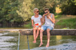 © .shock - couple enjoying watermelon while sitting on the wooden bridge