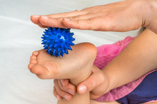 Mother Makes Foot Massage With Blue Massage Ball