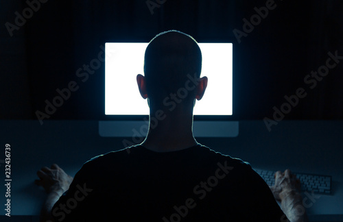 Fotografía Man with criminal intentions hacking from a desktop computer.
