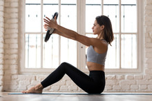 Sporty Woman Doing Pilates Toning Exercise For Arms And Shoulders With Ring, Fitness With Pilates Magic Circle In Hands, Working Out Wearing Sportswear, Indoor Full Length, White Yoga Studio Or Gym