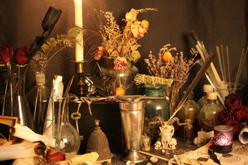 Antique Magic Book. Witchcraft Peacock feathers and candle background. Black candle Magic Ritual.