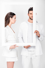 Wall Mural - adult couple holding white frame together isolated on white