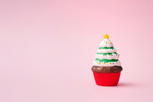 Christmas Tree Cupcake On Pink Background With Copy Space. Minimal Christmas Theme. New Year Food Concept.