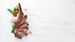 Steak on the bone. tomahawk steak On a white wooden background. Top view. Free copy space.