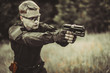 © johnalexandr - instructor with gun in forest leads aiming and posing on camera