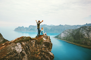 Wall Mural - travel couple enjoying view together on cliff edge in norway man and woman family healthy traveling 