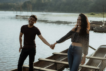 Wall Mural - couple with traditional canoe together on a lake