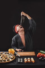 Wall Mural - hungry man is ready to eat the full fish. closup photo. studio shot.silly chef with opened mouth