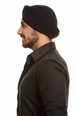 Wall Mural - Profile view of young happy Indian Sikh smiling