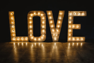 Wall Mural - the word love wood with light.