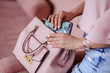 © cherry_d - Beautiful young blonde woman with light pink handbag and mobile phone. Portrait of pretty blonde girl in pink clothes.