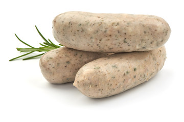 Wall Mural - Raw Nuremberg Sausages with herbs, isolated on a white background. Close-up.