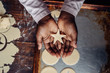© Stocksy - Black girl's hands holding a star shaped Christmas cookie dough