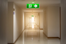 Green Emergency Exit Sign In Hotel Showing The Way To Escape