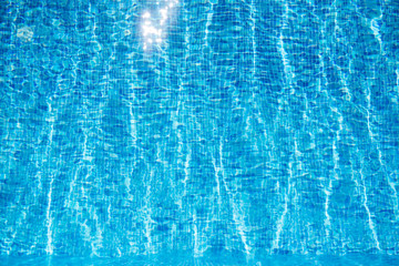 Blue swimming pool rippled water detail. Background