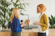© Stocksy - Female Co-Workers Chatting Over Coffee