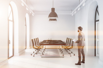 Canvas Print - White meeting room with black table, man