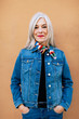 © Stocksy - Portrait of woman with long gray hair in denim
