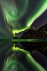 norway - lofoten island - aurora reflexion in water of haukland explosion