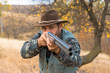 © Mountains Hunter - Hunter with a hat and a gun in search of prey in the steppe