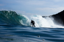 A Surfer Riding A Heavy Wave