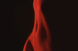 © Stocksy - stomach in red light in the dark