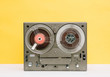 © Stocksy - Vintage reel to reel in front of a yellow background