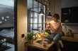 © Stocksy - Young woman decorating kitchen for Christmas