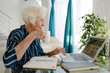 © Stocksy - Senior woman using laptop at home