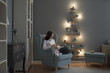 © Stocksy - Beautiful caucasian woman unwrapping Christmas presents