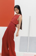 © Stocksy - Asian fashionable female model with long hair in red in abstract space ./Fashion series