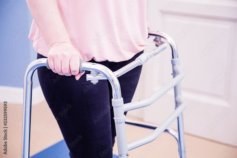 40 year old female patient practice walking with a walker in the Stock ...
