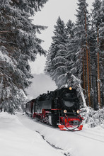 Steam Train Riding Through Winter Forest